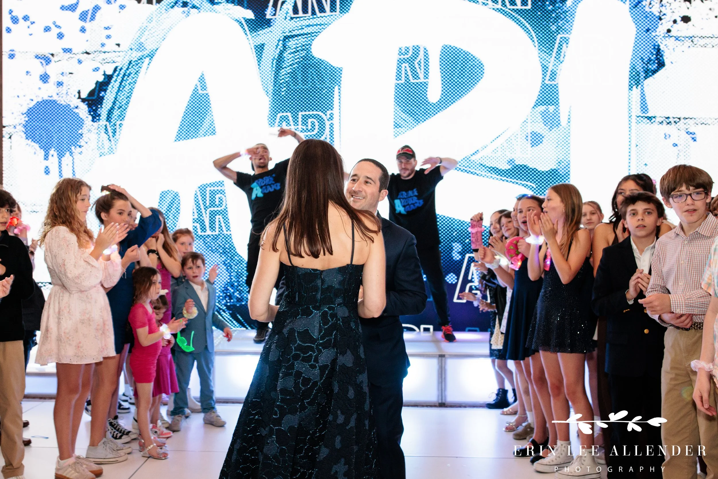 Husband looking at wife lovingly during grand entrance w hotel bar mitzvah nashville