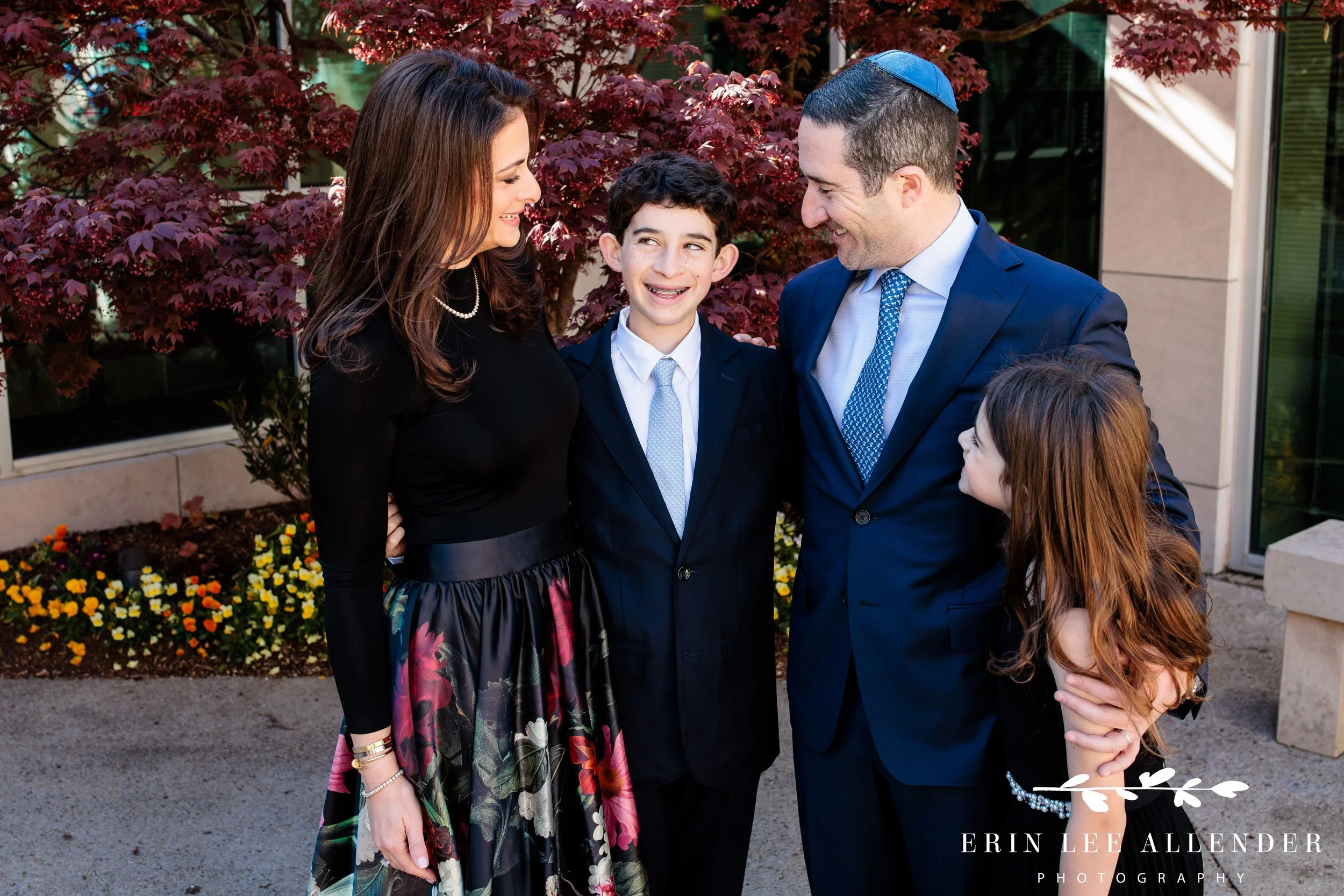 Bar mitzvah with siblings posing together at The Temple