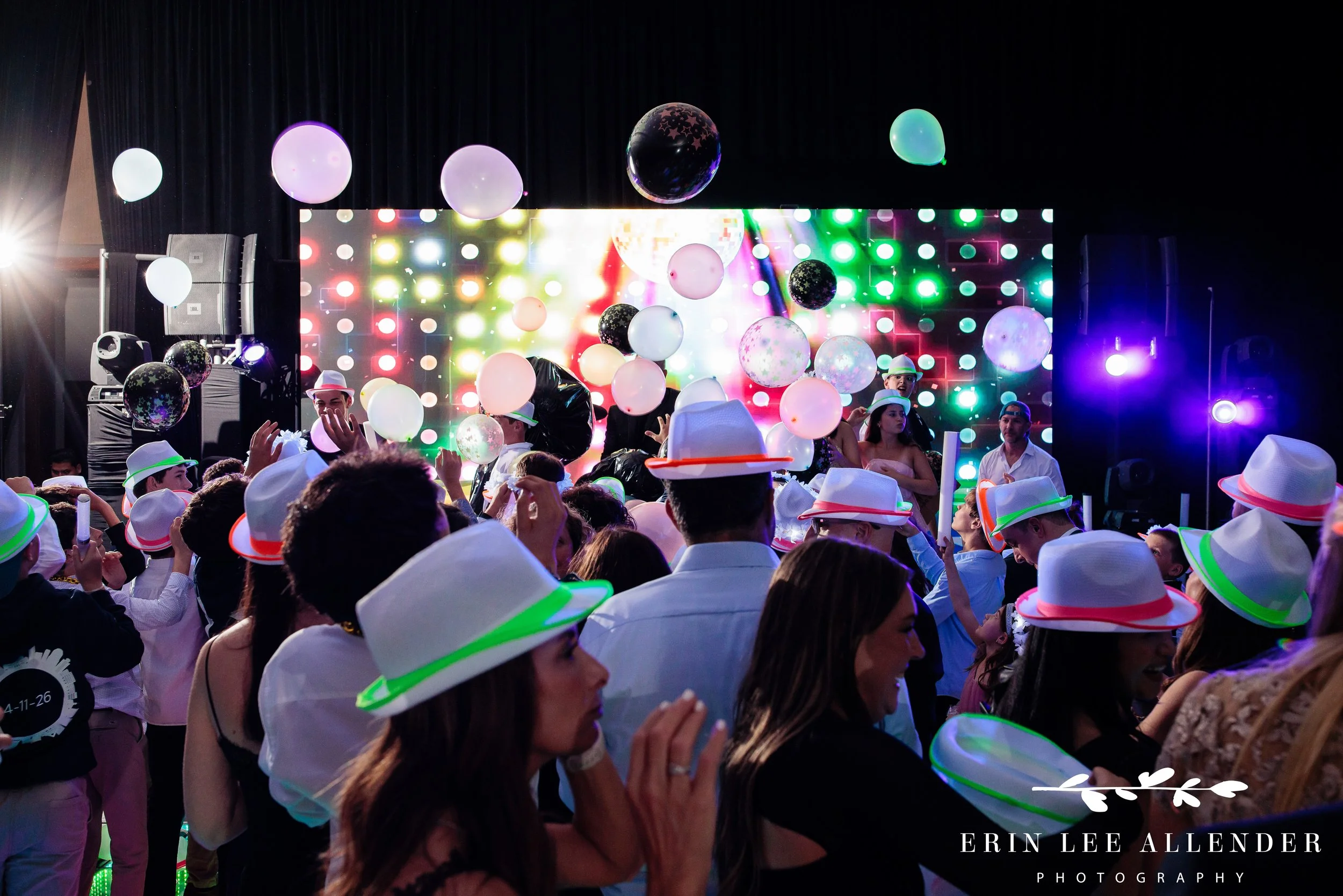 Balloons tossed in air during dance floor celebration