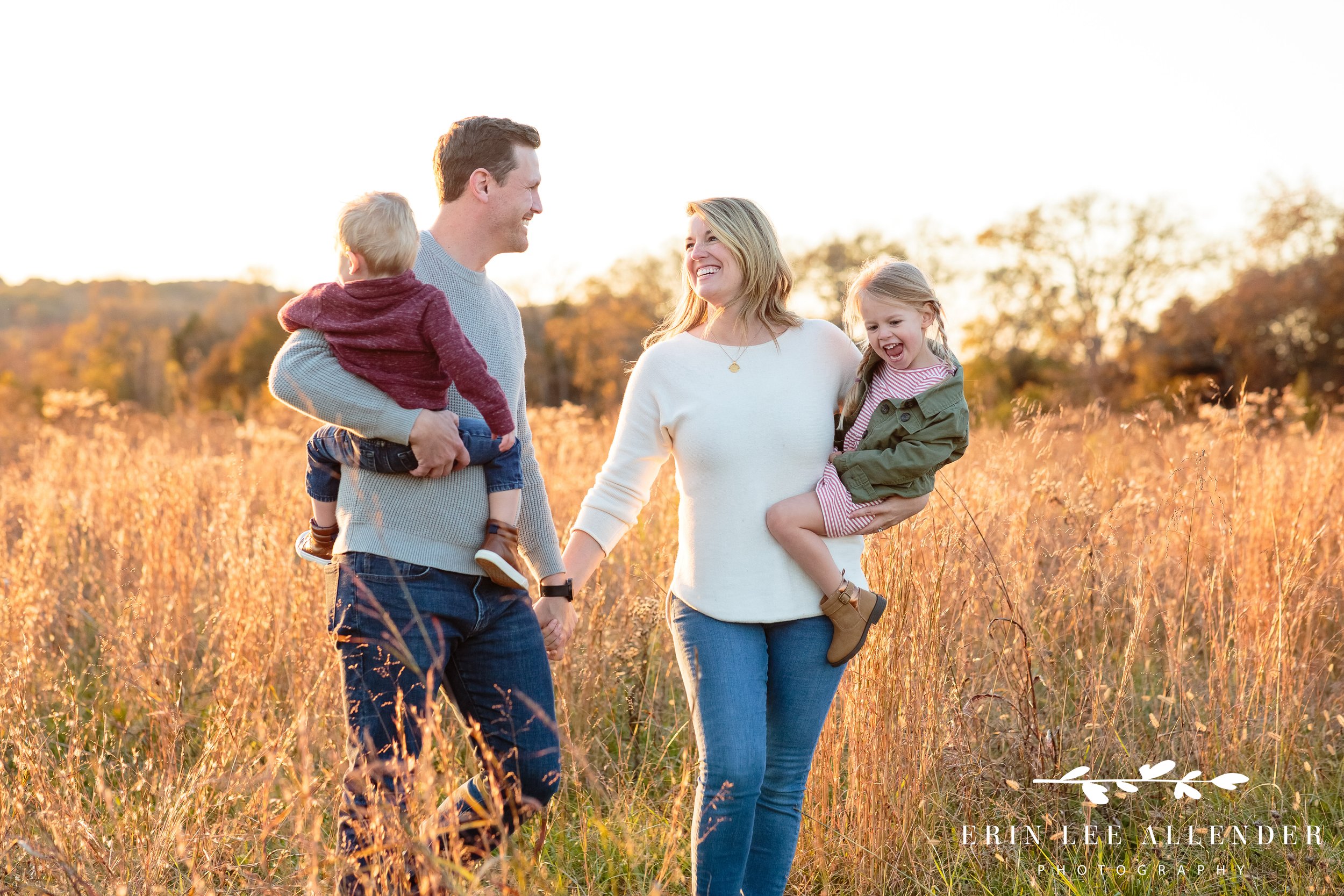 Wide shot of the Iten family standing in a golden field in Gallatin during a sunset family photography session.