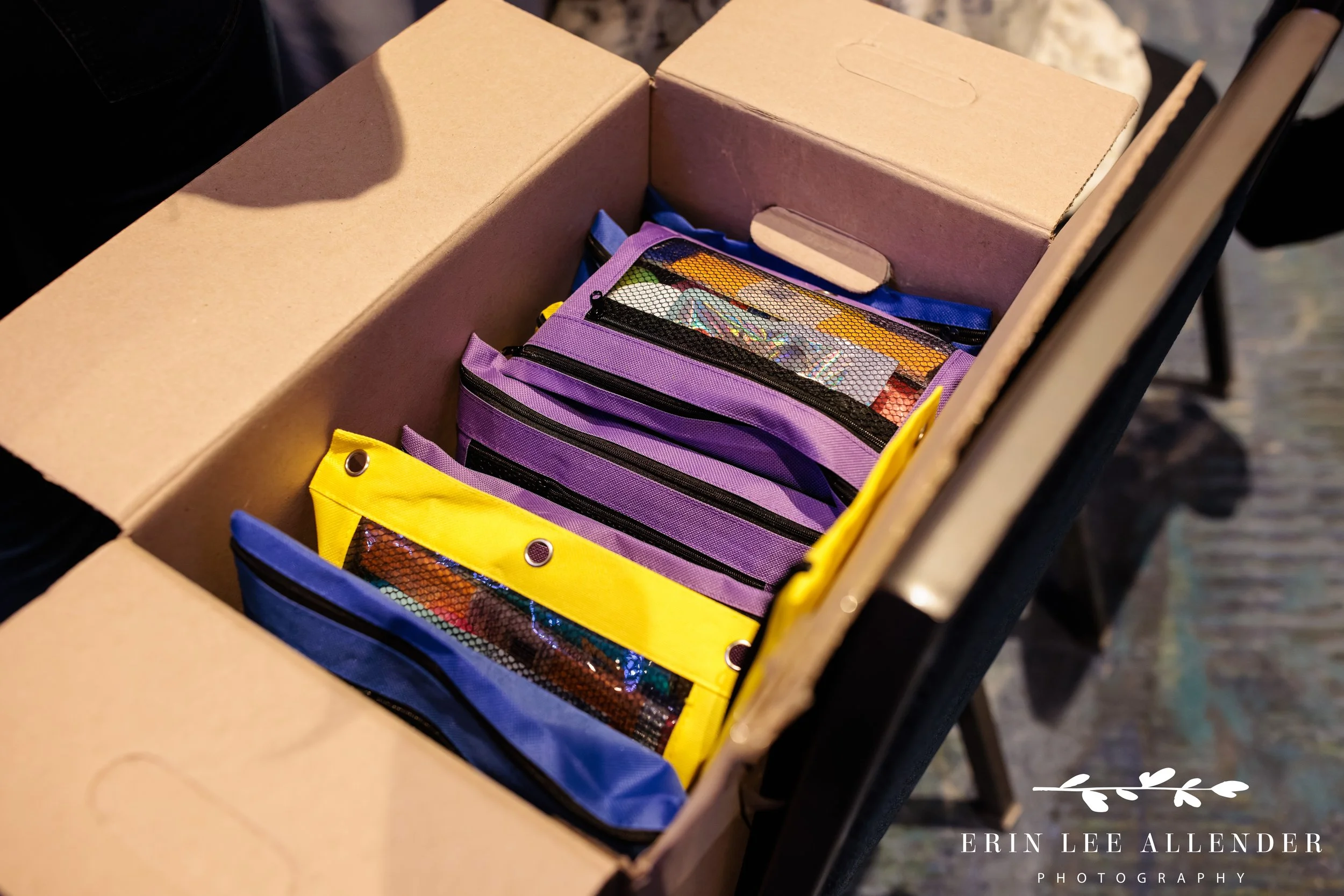 Nashville corporate event photographer capturing a box of filled pencil bags during RubinBrown's Hands On service project at Gaylord Opryland Resort