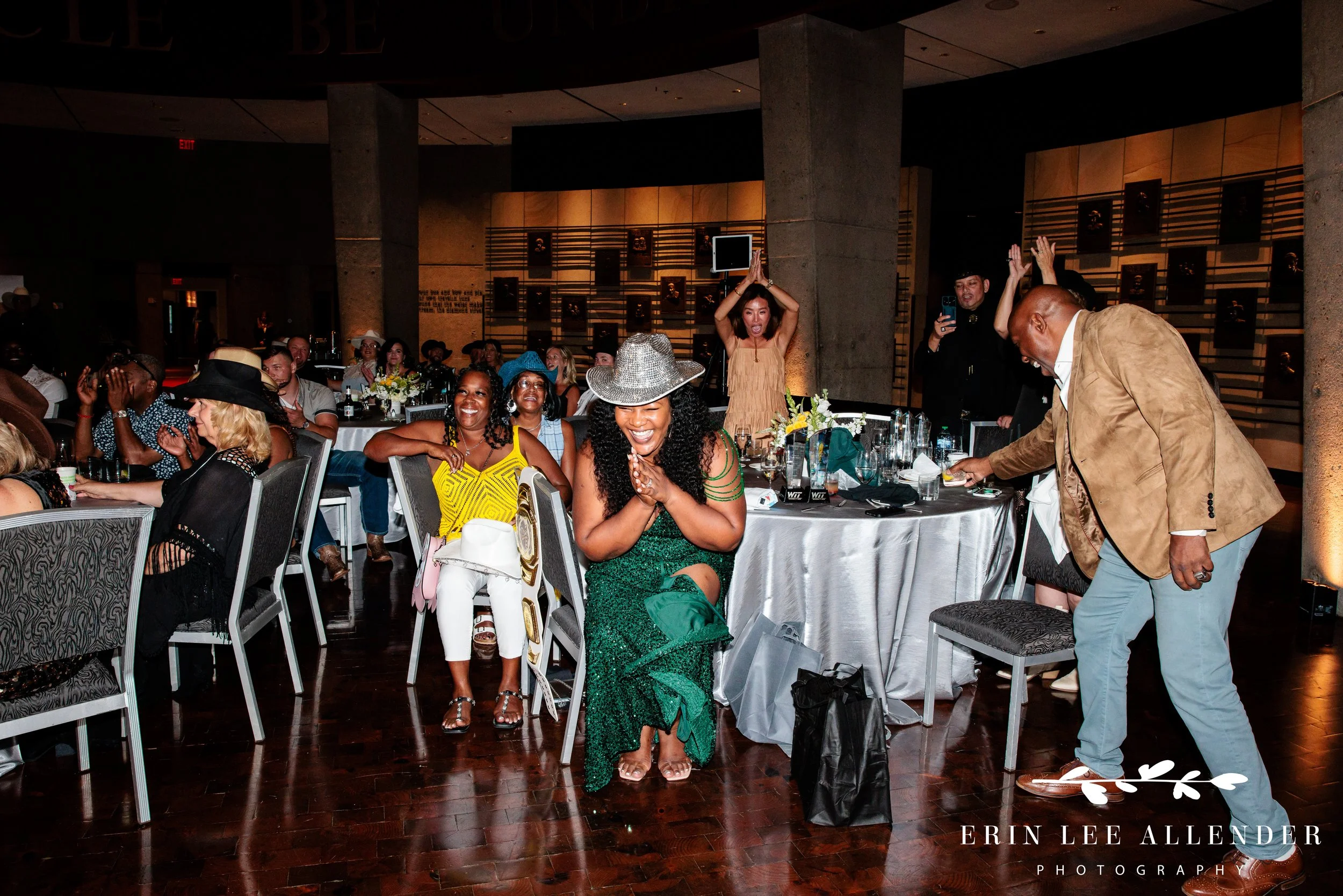 award winner getting from seat after name announced at country music hall of fame