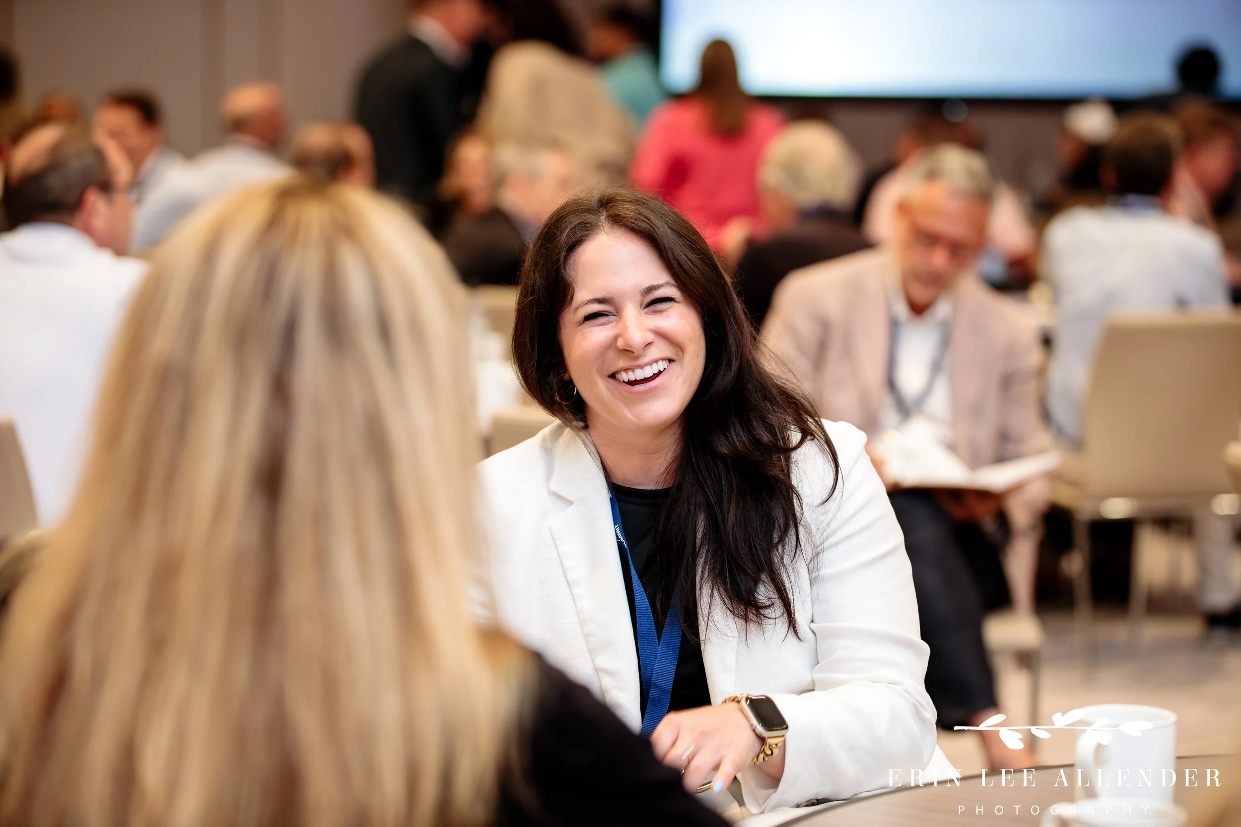 Nashville corporate event photography — CBIZ Nashville Summit attendees laughing during a session at The Conrad