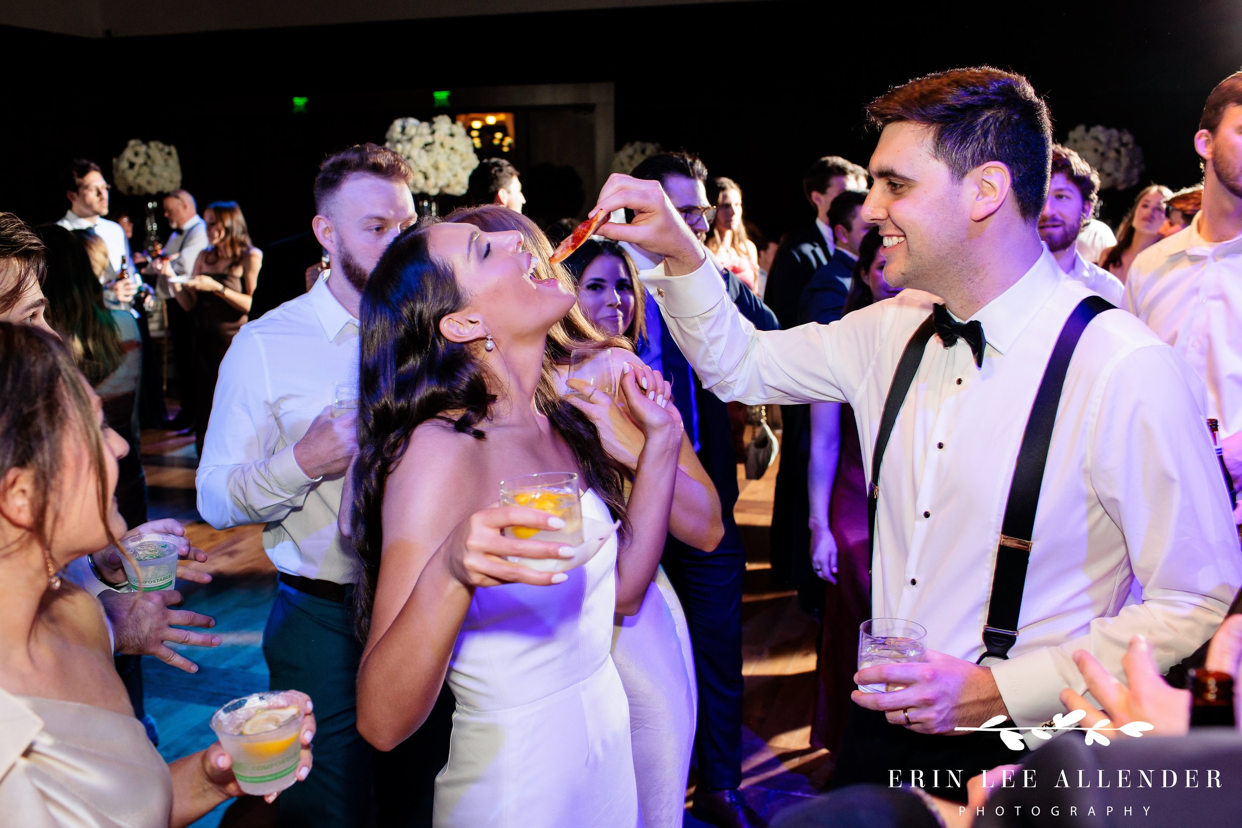 Nashville wedding photography — groom feeding the bride a late-night pizza slice at Country Music Hall of Fame