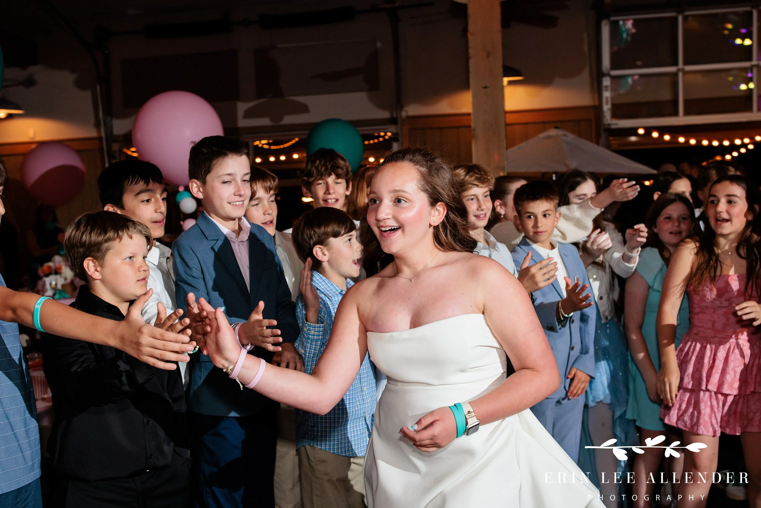Nashville mitzvah photography — bat mitzvah giving high fives during grand entrance at Loveless Barn