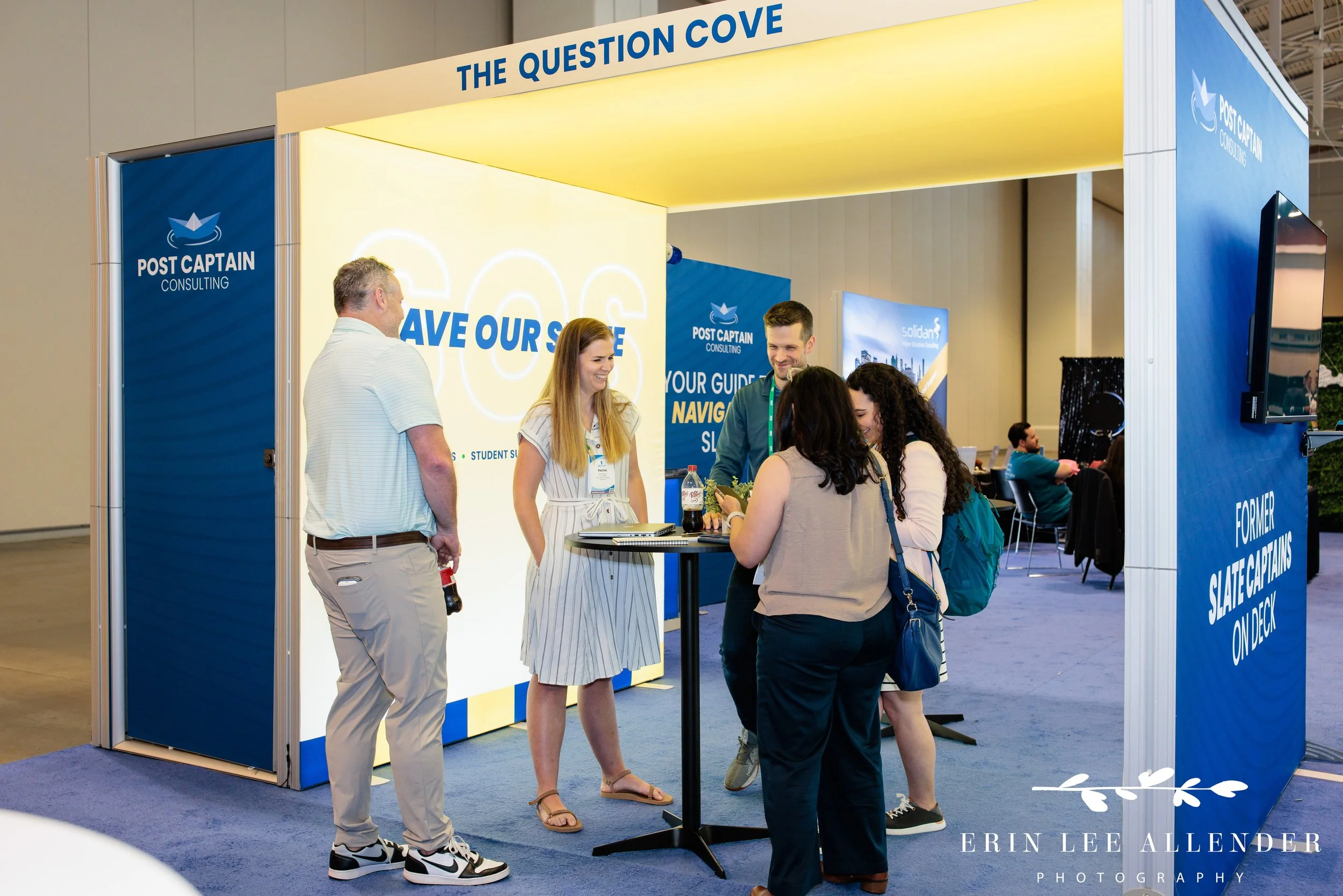Nashville conference photography — wide shot of a conversation at the Post Captain booth during the Slate Summit, Music City Center