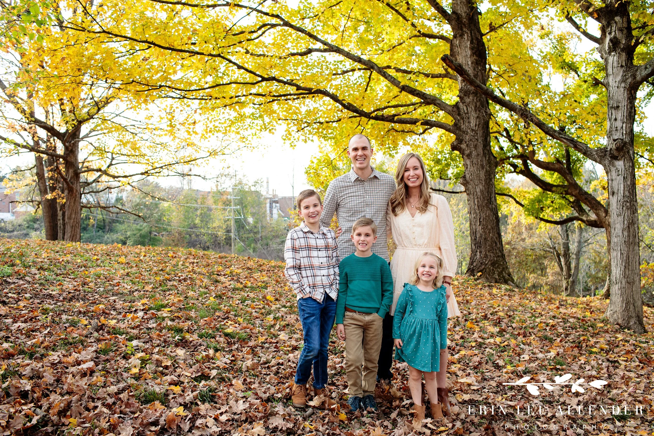 Nashville family photography — family of five posed together at the base of a tree during a fall mini session at Ellington Agricultural Center