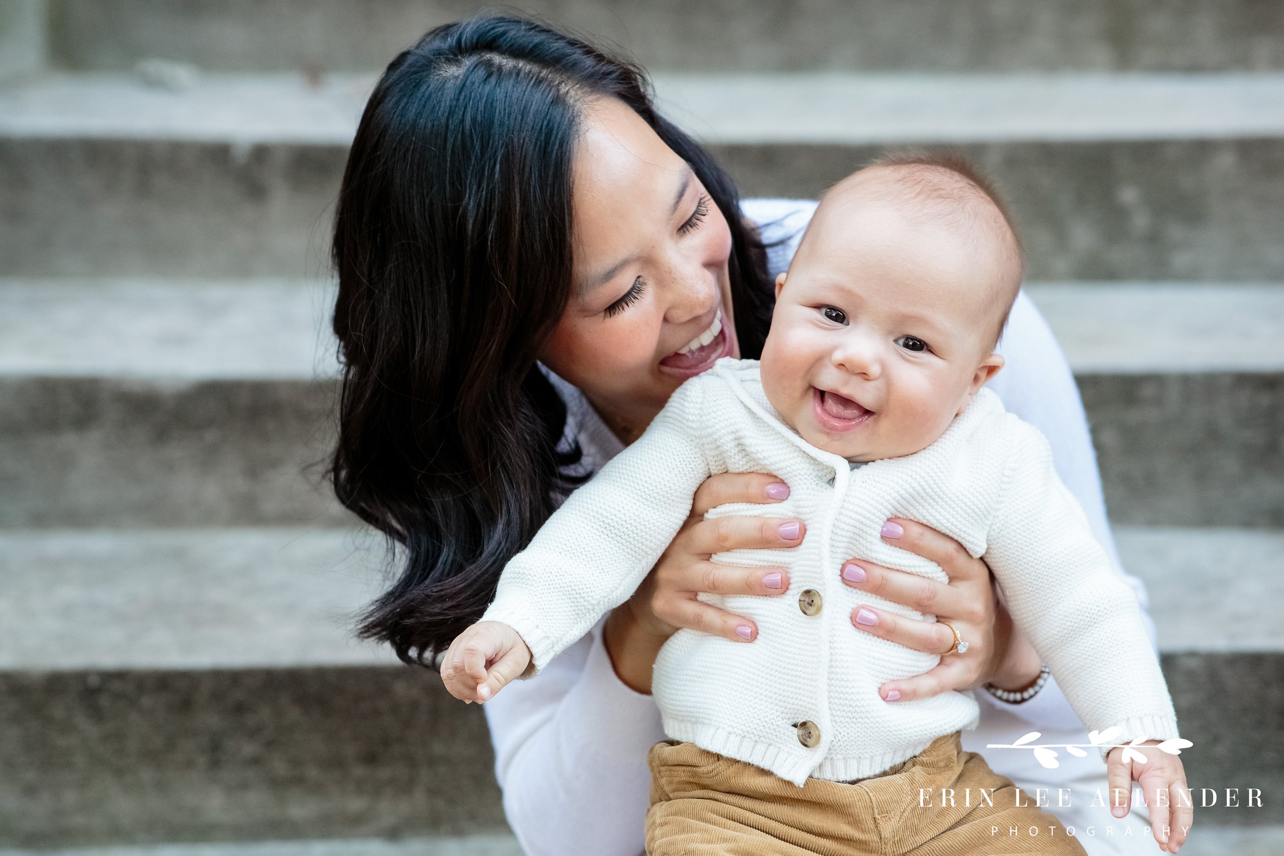 Four-month-old baby held in parents’ arms during a Vanderbilt campus family photography session.