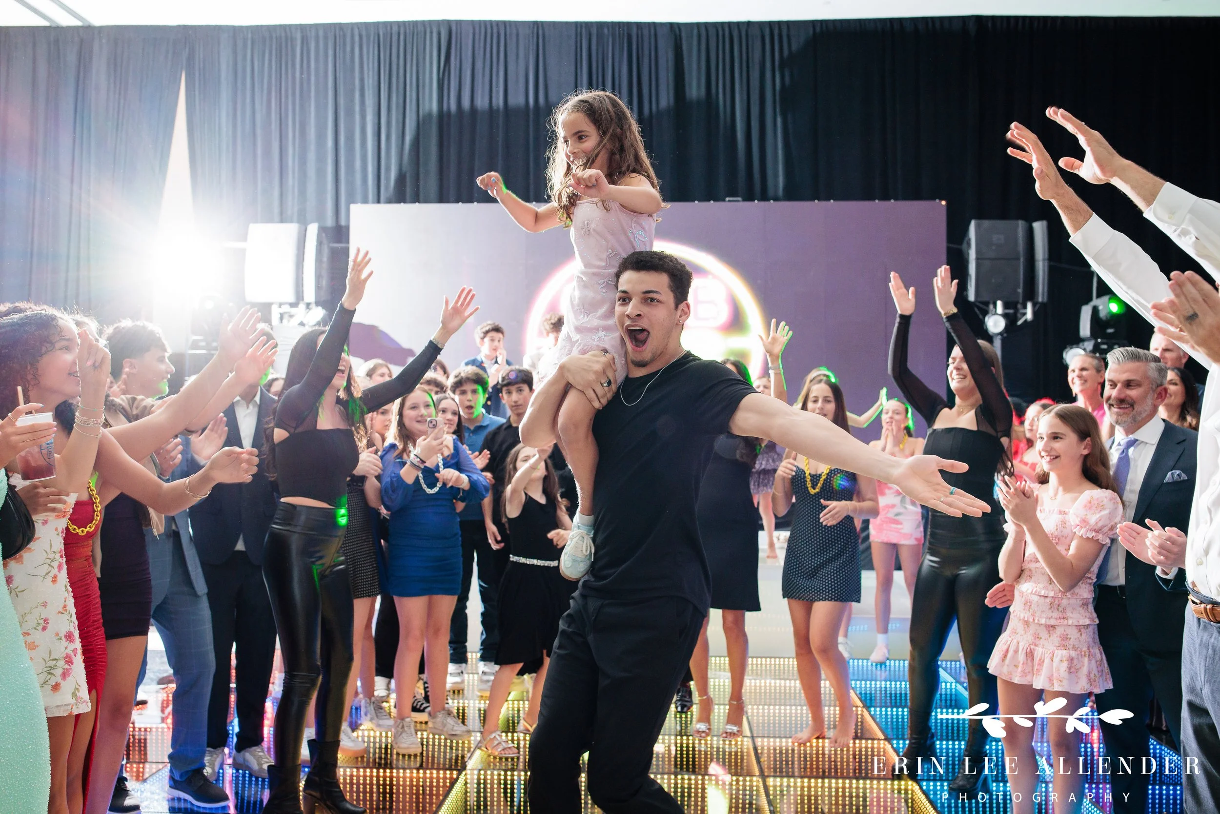 Youngest sibling entering on shoulders during entrance