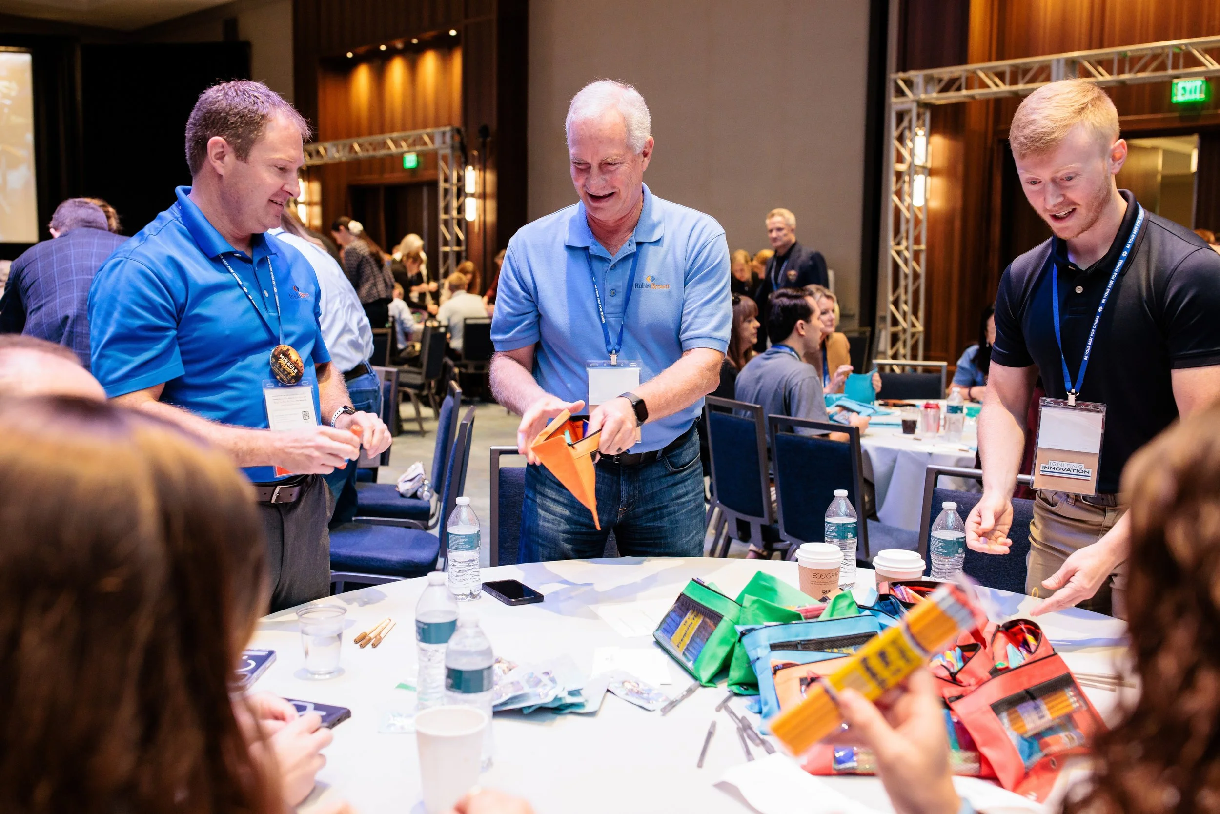 Nashville conference photographer capturing a group filling pencil bags during RubinBrown's service project with Hands On at Gaylord Opryland Resort