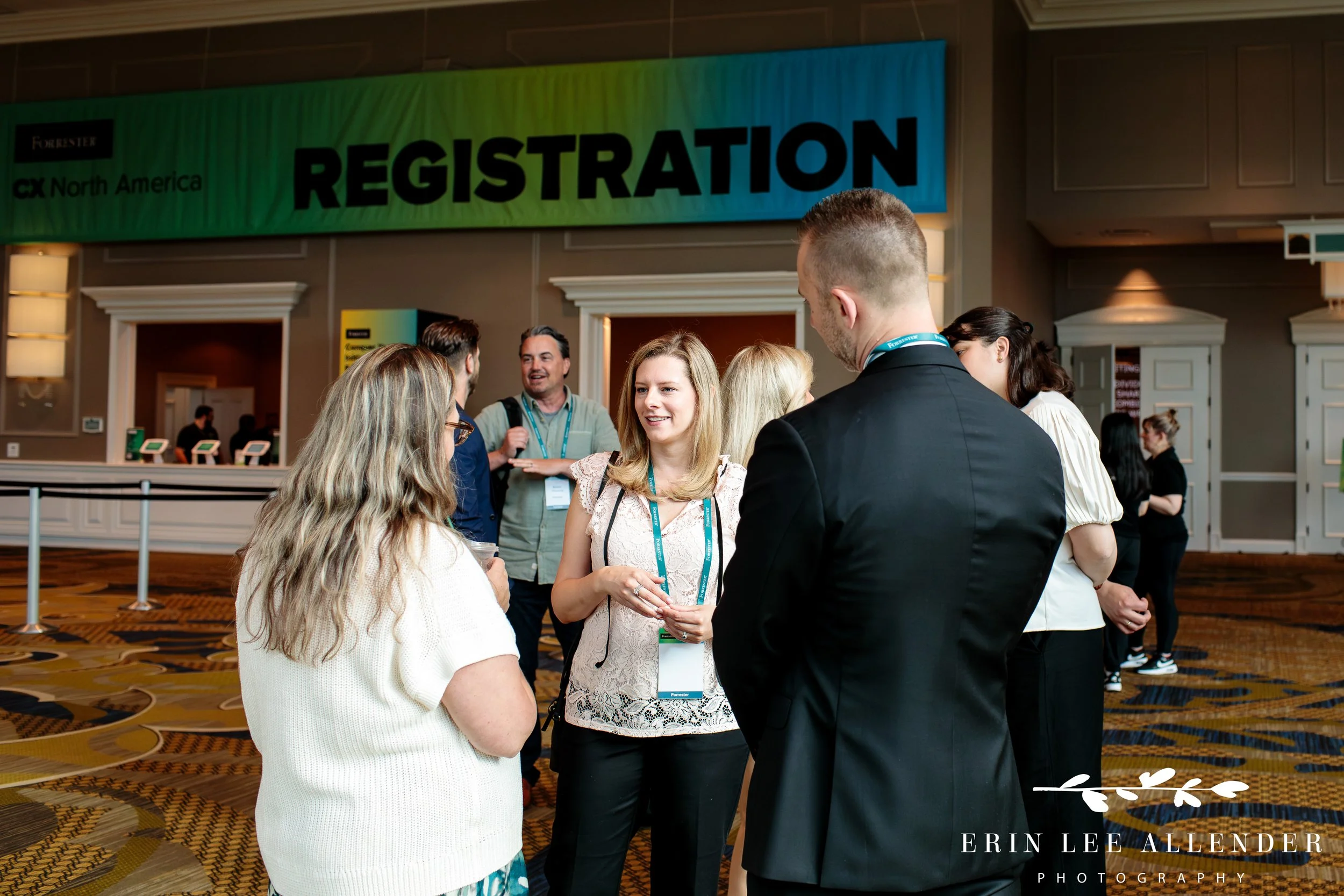 People networking in front of registration sign at corporate CX conference Gaylord Opryland Hotel