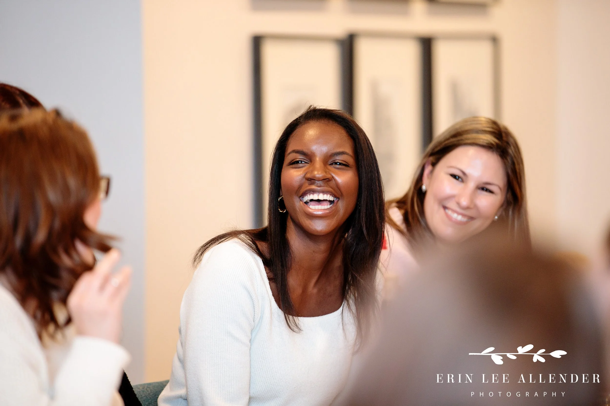 Group of wedding planners sharing conversation and laughter during dinner at Nashville Reserve during corporate retreat photography coverage