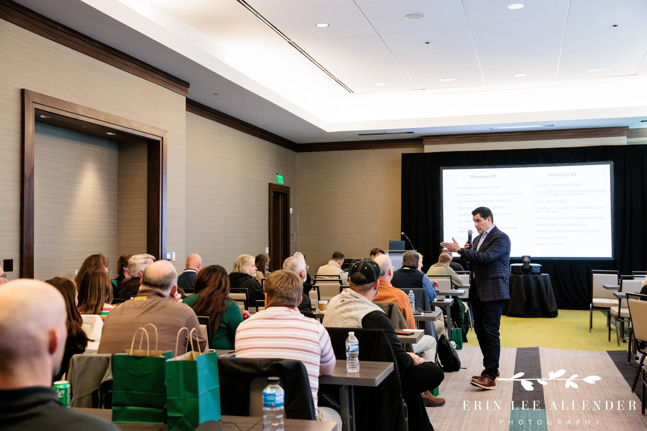 Nashville corporate event photographer — TruGreen franchisees working through a sales role-play exercise at tables during Franchise Meeting Day at the Omni Nashville