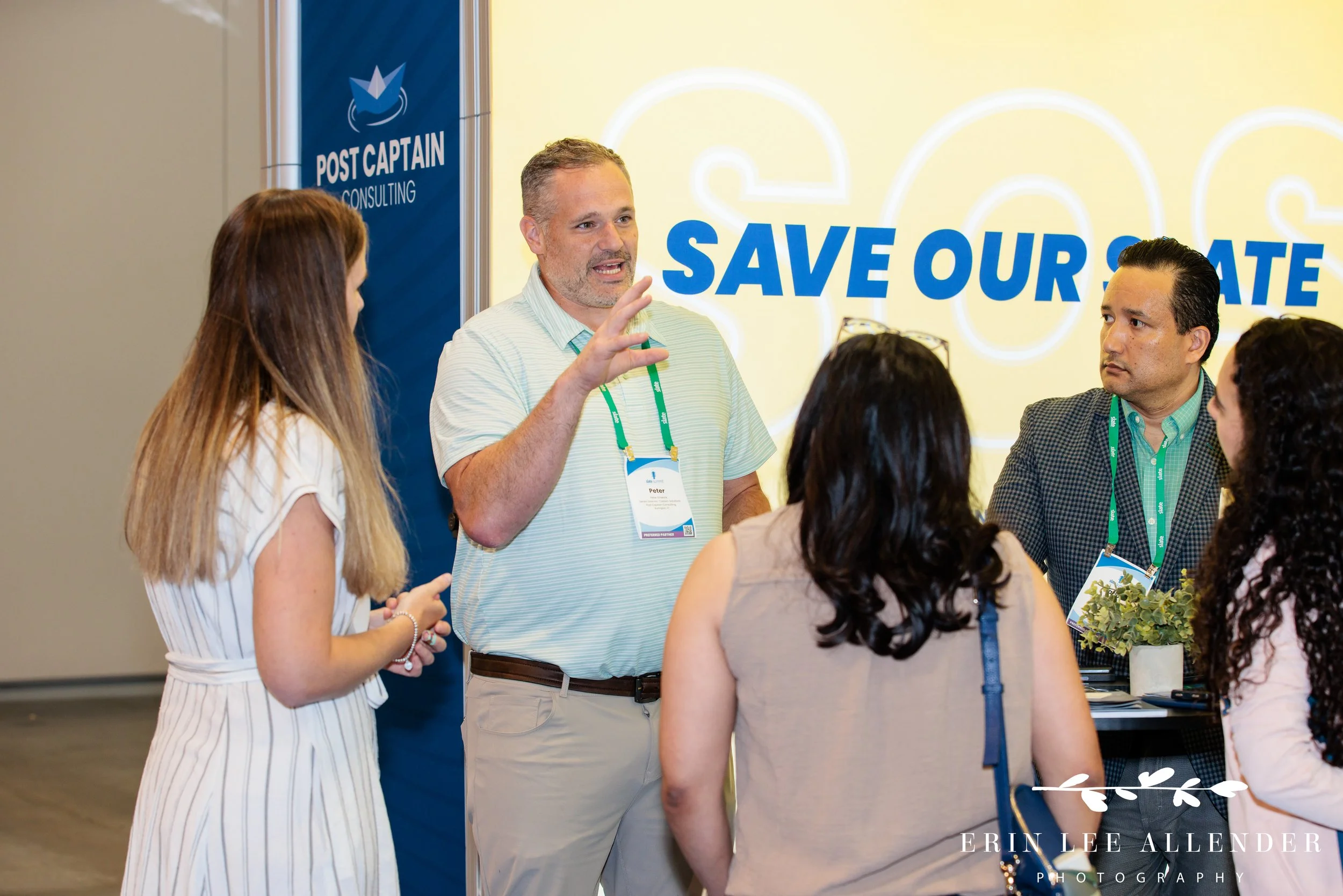 Nashville conference photographer — Post Captain consultant mid-conversation with an attendee at the Slate Summit booth