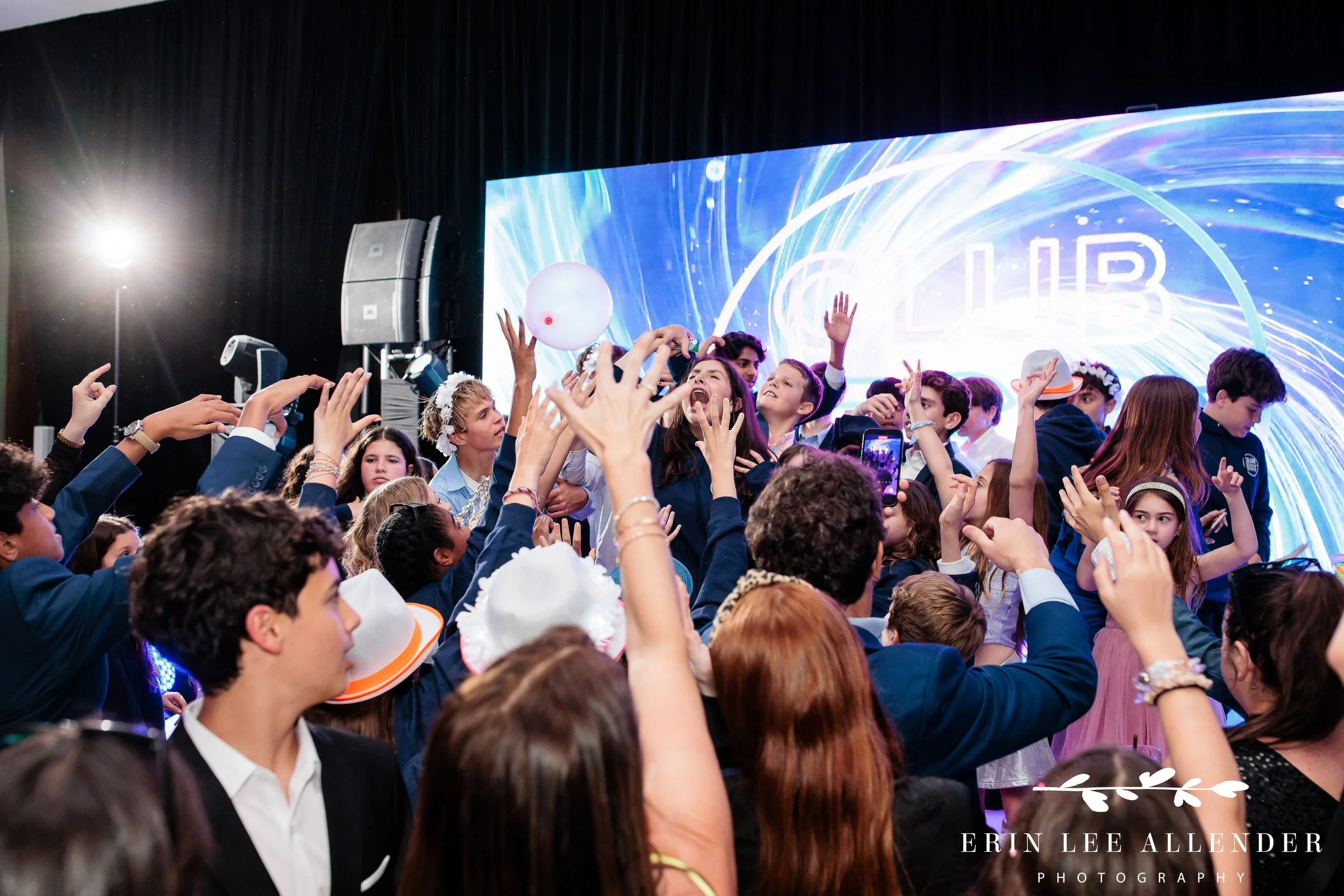 Surrounded by friends on stage during party