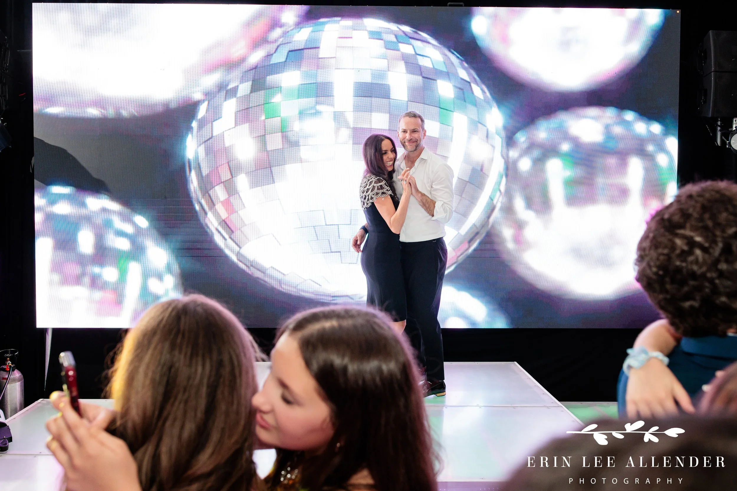 Parents watching guests dancing