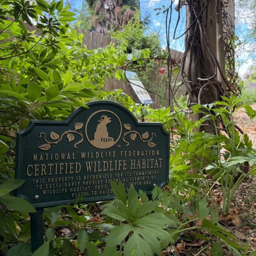Close up of the green and gold Certified Wildlife Habitat sign