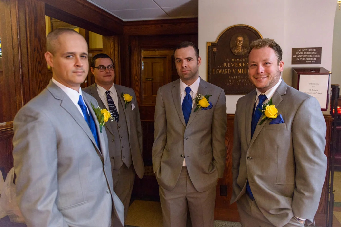 Groomsmen and the groom in the back of St James Catholic Church before the wedding in Falls Church, Virginia