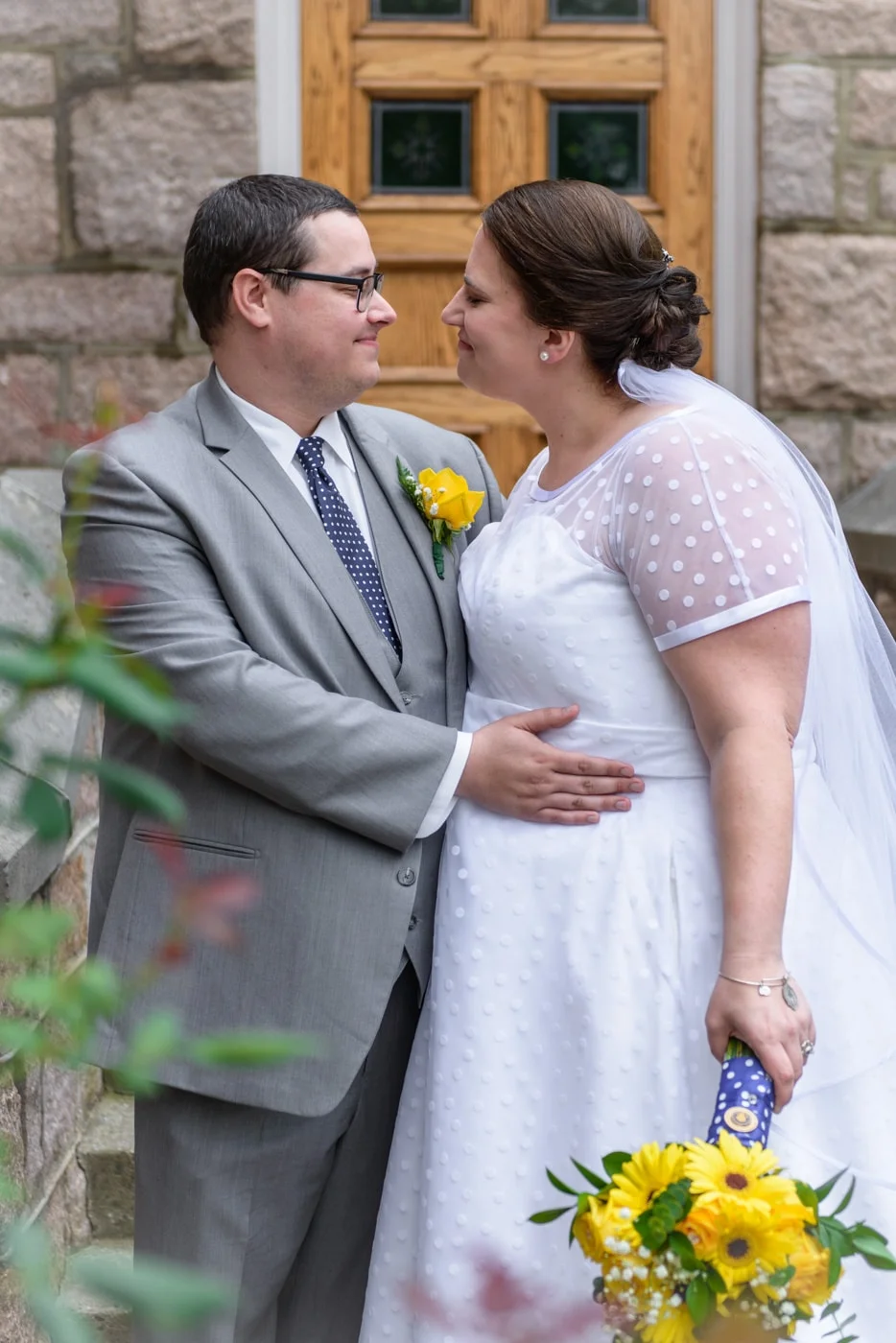 The bride and groom look lovingly at each other outside St James Catholic Church in Falls Church, Virginia