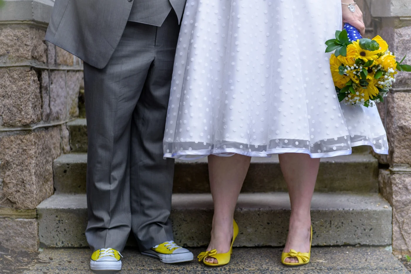 Close up of the bride and groom’s details including tea length wedding dress and yellow shoes