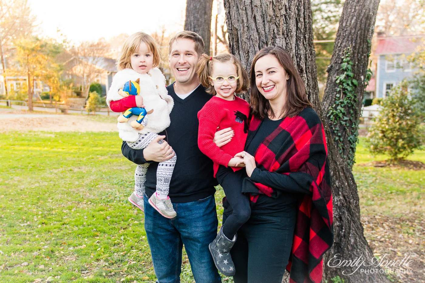 A family with two little girls posing for a formal photo at Clifton Town Park in Fairfax County, Virginia