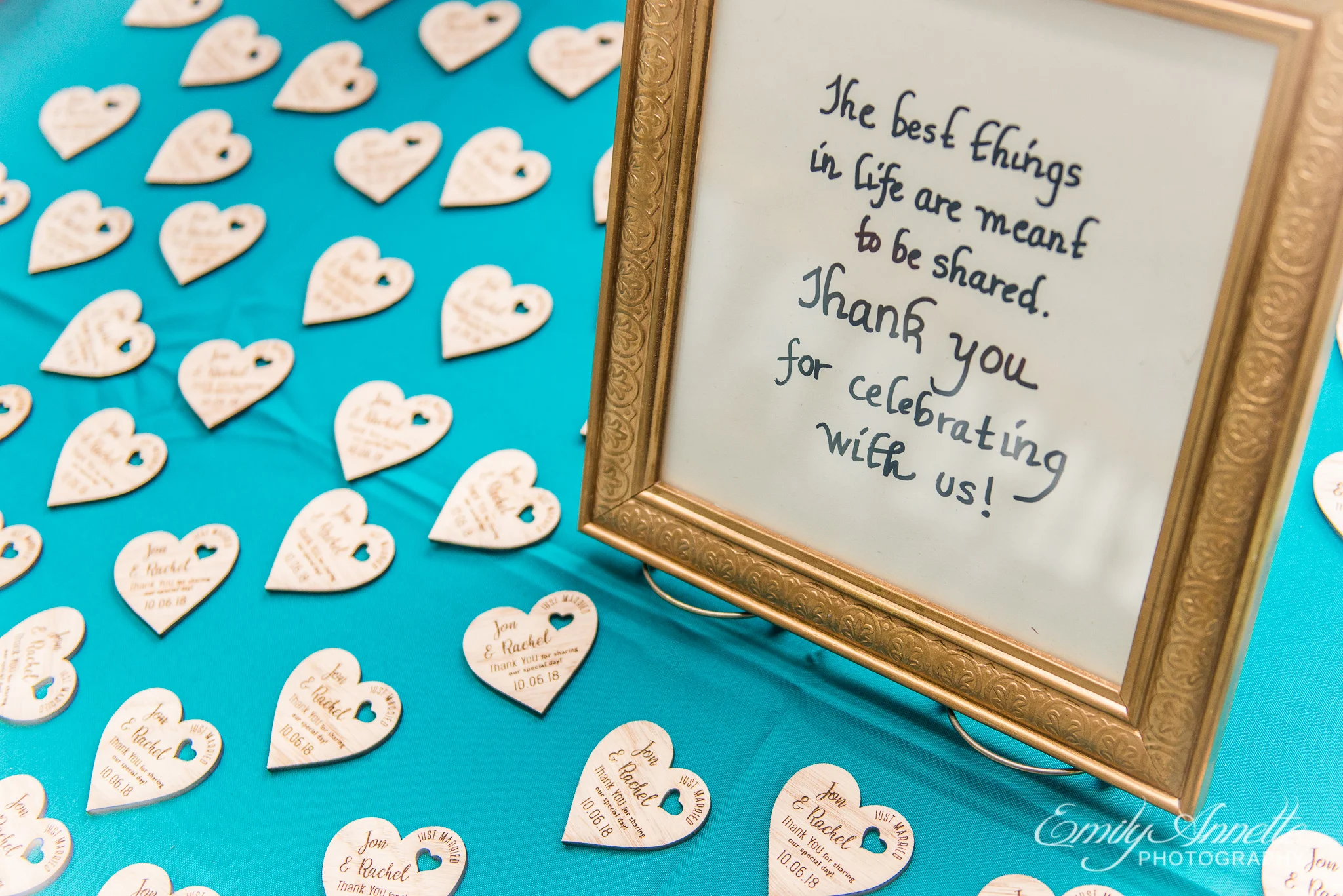 A table of wedding favors with wooden magnet hearts with personalized engraving for a country wedding reception at Amber Grove near Richmond, Virginia
