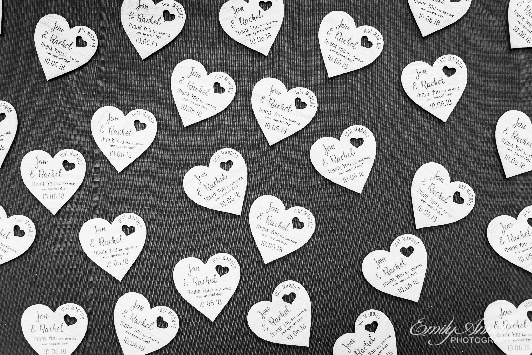 A table of wedding favors with wooden magnet hearts with personalized engraving for a country wedding reception at Amber Grove near Richmond, Virginia
