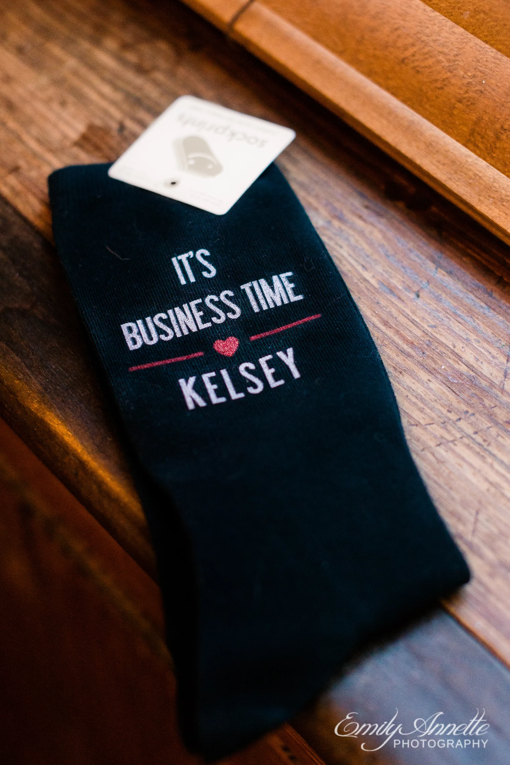 A pair of groom’s socks that say “It’s business time Kelsey” as a gift from the bride to the groom before their wedding at Willow Oaks Country Club in Richmond, Virginia