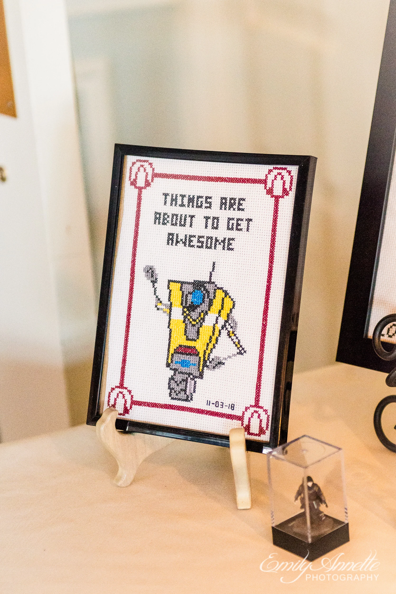 A cross stitch that says “things are about to get awesome” at a wedding reception at Willow Oaks Country Club in Richmond, Virginia
