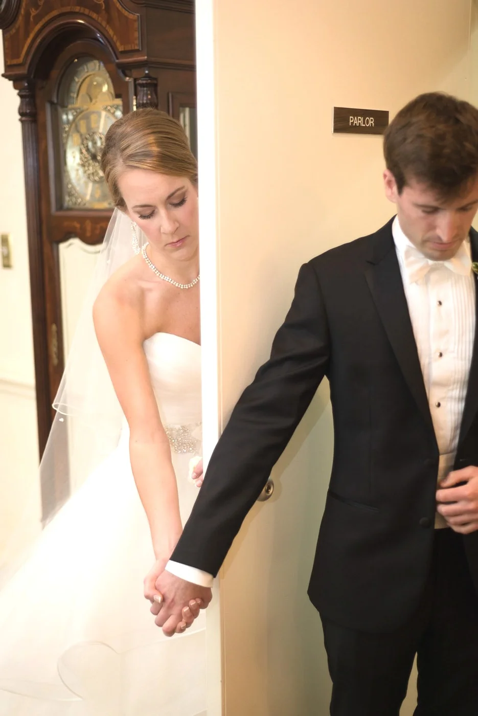 A bride and groom pray together before their wedding ceremony at a Catholic Church in Fairfax, Virginia
