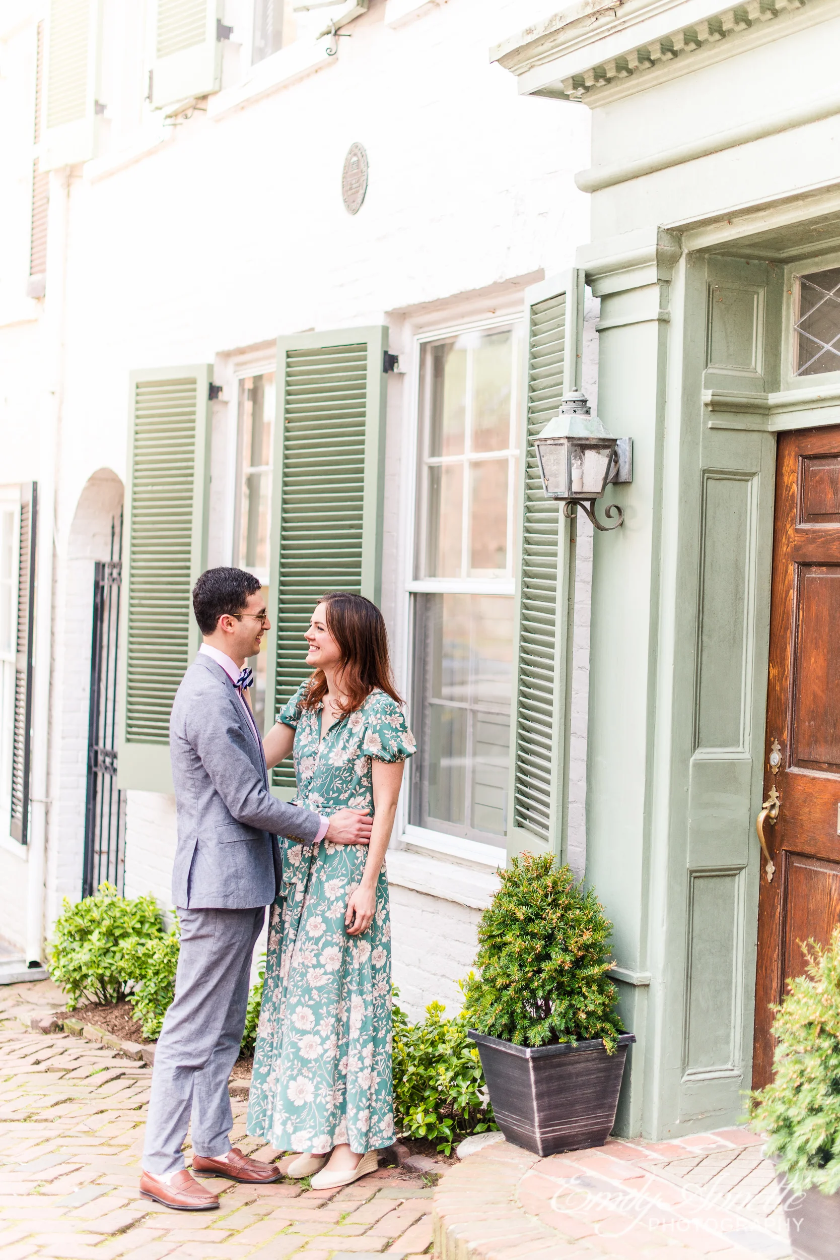 A couple poses for a portrait during their spring engagement session in Old Town Alexandria, Virginia