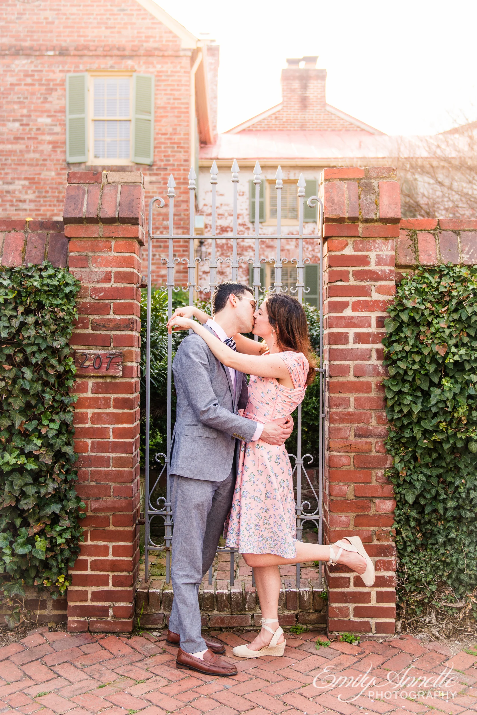 A couple poses for a portrait during their spring engagement session in Old Town Alexandria, Virginia