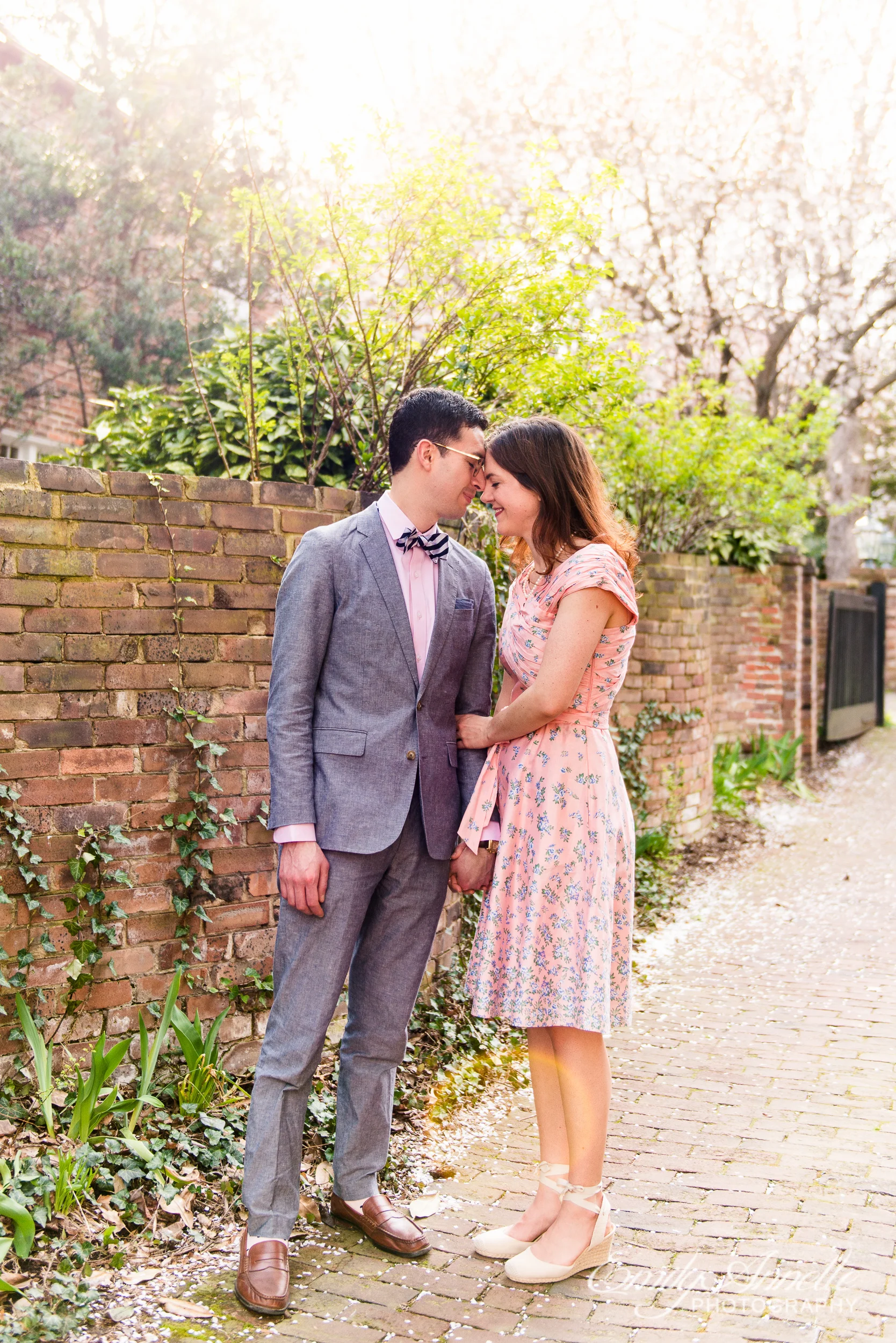 A couple poses for a portrait during their spring engagement session in Old Town Alexandria, Virginia