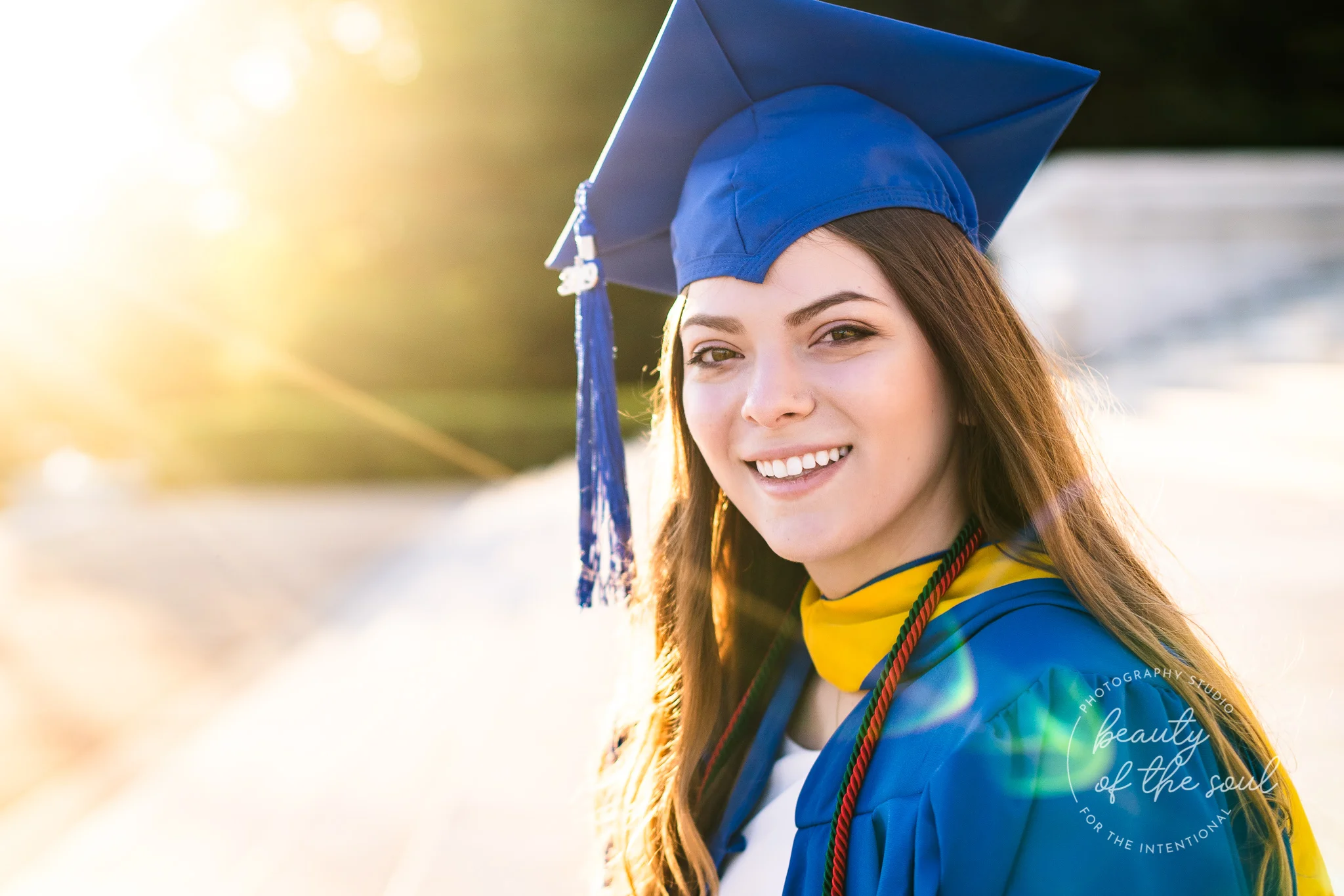 A close up of a graduate from Marymount University in Arlington, Northern Virginia sitting on the steps of the Jefferson Memorial for her cap and gown session in Washington, DC