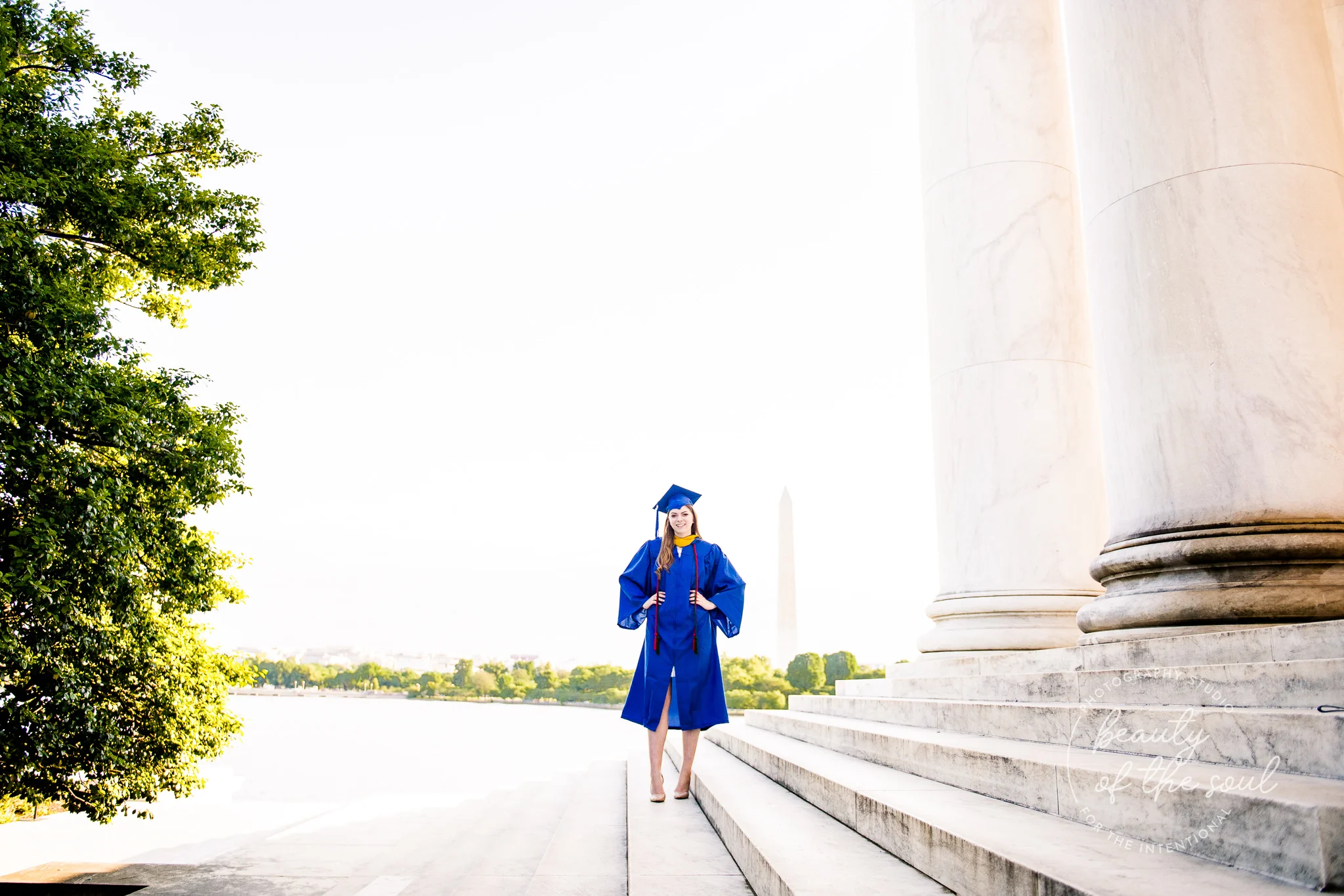 A graduate from Marymount University in Arlington, Northern Virginia standing on the steps of the Jefferson Memorial for her cap and gown session in Washington, DC