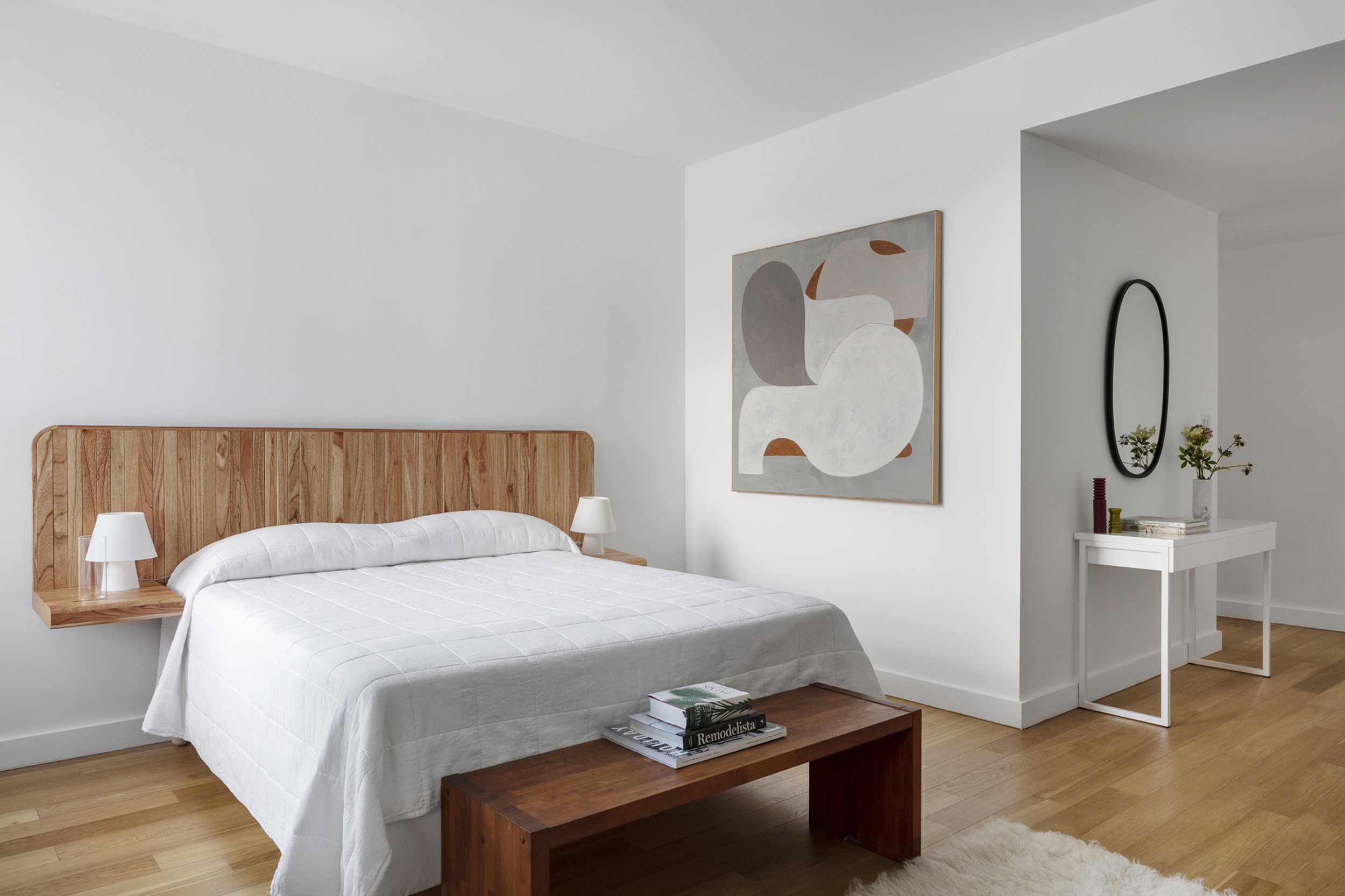  Hovey Design  North 7th PH1c   On Brooklyn’s water front. Hovey Design stages the large principal bedroom with a floating wooden headboard that offers nightstand surface. 