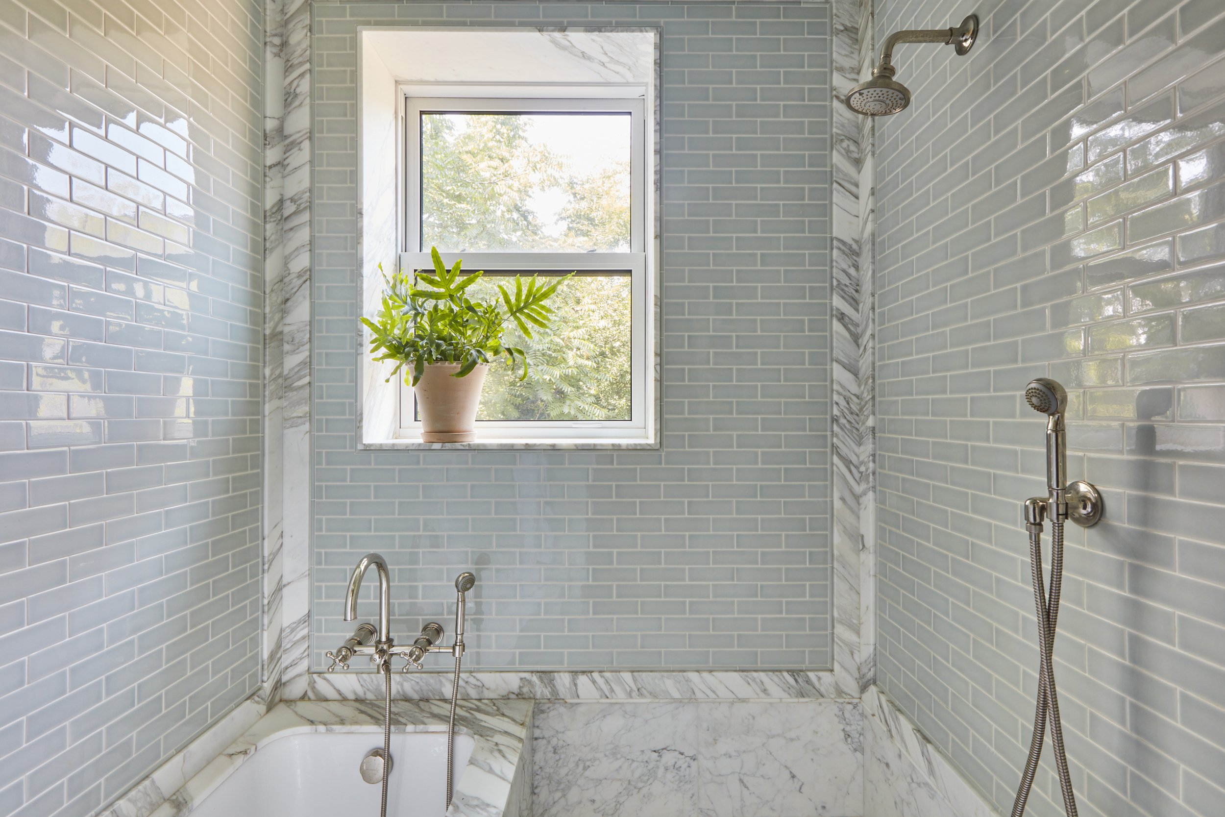  Charlap Hyman &amp; Herrero NV / Design Architecture, Kim Letven  Private Brooklyn Townhouse   This spacious bathtub and shower titled head to toe features a window to their backyard with a large tree that allows natural light and privacy. 
