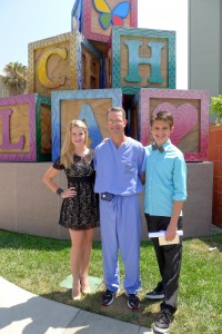 Alex Dale and Madison Curtis present a check to Dr. David Skaggs, Chief of Pediatric Orthopedics at Children's Hospital Los Angeles