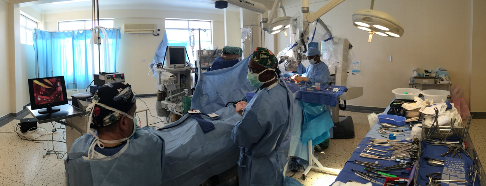 Alex Muhindo operating on large brain tumor at Mbarara Hospital in Uganda independently as the first trained Neurosurgeon in the Duke Mulago Neurosurgery Training Program. Dr. Haglund watching on video as Dr. Muhindo removes the tumor. 