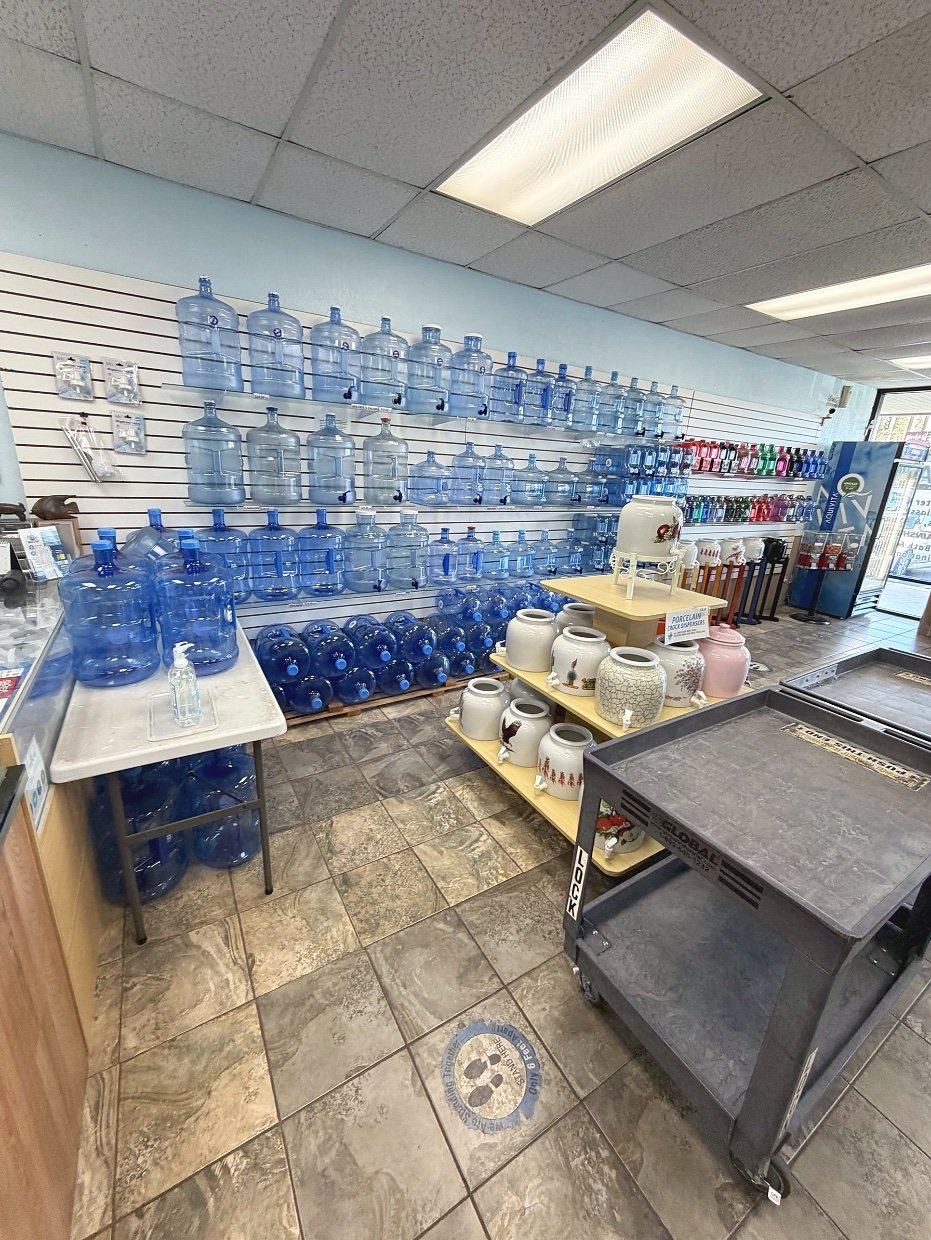 Self-service bottle cleaning and refill area inside Fresh Alka Water on Mission Gorge, San Diego — bring your jugs and refill with purified or alkaline water
