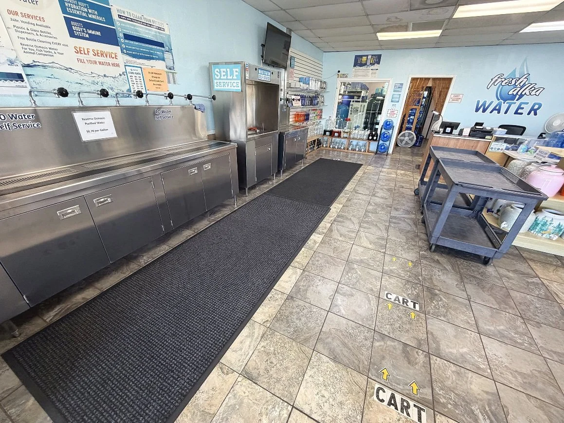 Inside Fresh Alka Water on Mission Gorge in San Diego — self-serve water refill stations and rows of reusable jugs
