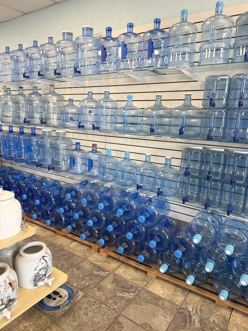 Shelves of refillable five-gallon water jugs at Fresh Alka Water, Mission Gorge, San Diego — refill and save plastic