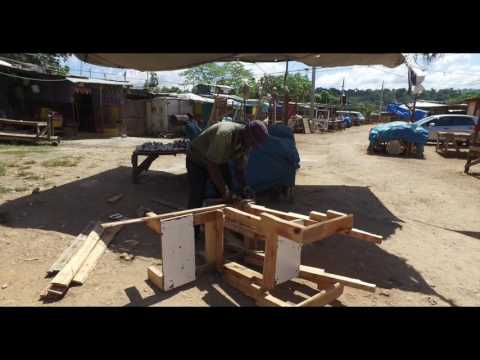 Jamaican man making a chair at a farmer's market