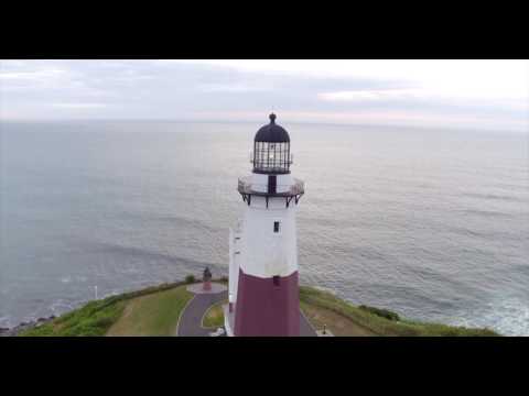 Circling around Montauk Lighthouse, at sunrise against backdrop of open ocean