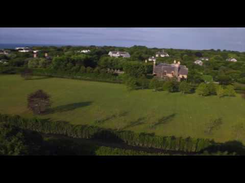 Slow aerial pass through grand estates of East Hampton
