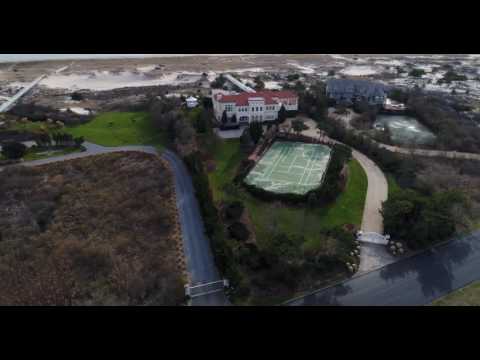 Broad aerial flight around three grand oceanfront houses in Southampton, NY