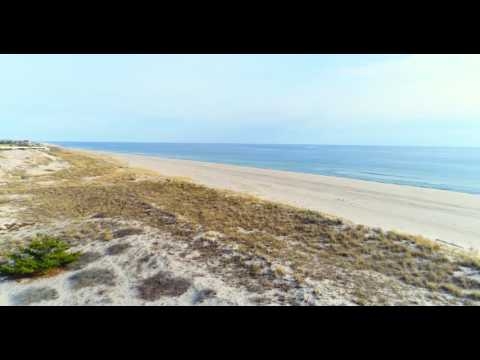 Low aerial flight over large oceanfront houses in Southampton, NY