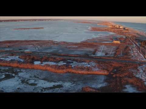 Aerial pann of frozen Lond Island bay and Atlantic Ocean