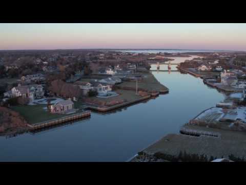 Aerial pass over waterfront houses along Dune Road, Westhampton Beach, Winter