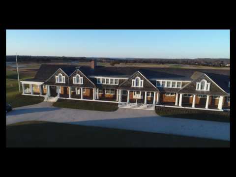 Aerial approach towards and above country club clubhouse, Hamptons